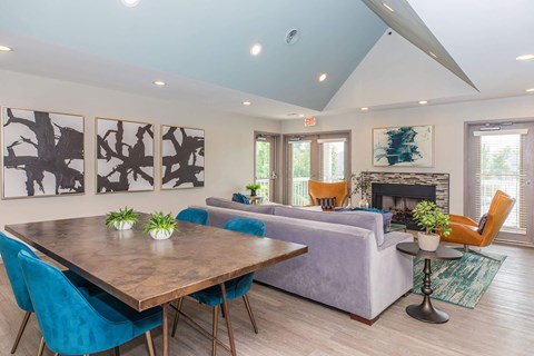 a living room with a couch table and chairs and a fireplace