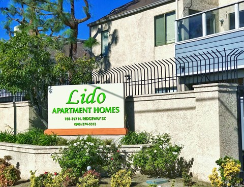 a sign for lido apartment homes in front of a building