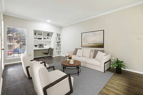 a living room with a couch and chairs and a table