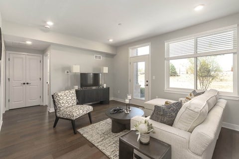 a living room with a white couch and a tv