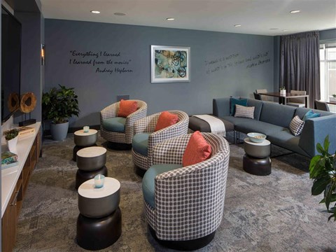 a living room filled with furniture and a blue wall
