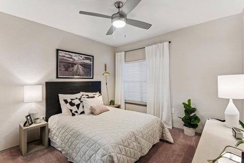 A bedroom with a bed, a ceiling fan, and a painting on the wall.at Onyx183, Texas, 78729