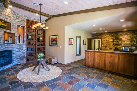 a living room with a fireplace and a wooden table