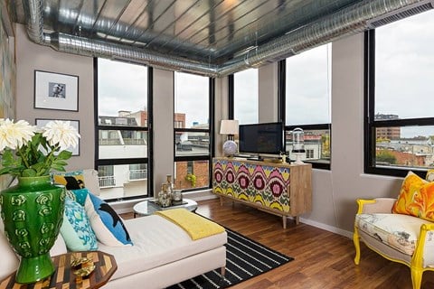 a living room with a view and a couch and a television