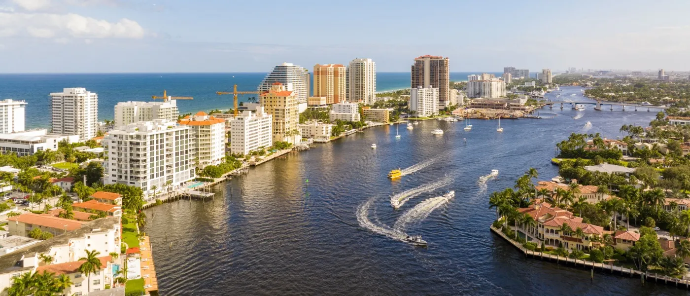 Boats navigating through Fort Lauderdale's waterways during Labor Day Weekend traffic, set against the backdrop of one of South Florida’s coastal cities known for offering some of the best affordable neighborhoods for waterfront living and lifestyle convenience.