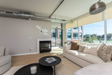 a living room with a couch and a coffee table and a fireplace