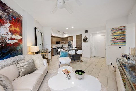 a living room with a white couch and a white coffee table