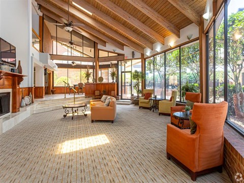 a large living room with furniture and large windows