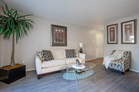 a living room with a couch and a glass coffee table