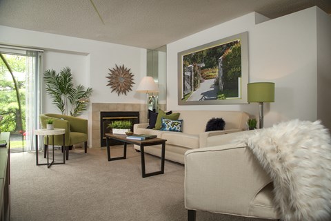 a living room with a couch and a chair and a fireplace