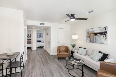 A living room with a brown chair and a white couch.
