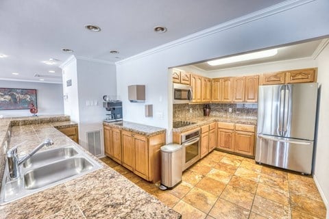 a large kitchen with a round ceiling and wood cabinets at Juniper Springs Apartments, Austin, TX