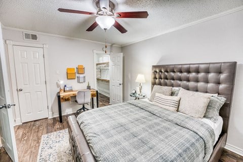 a bedroom with a bed and a ceiling fan