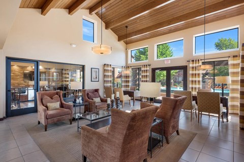 a living room with couches and chairs and a table