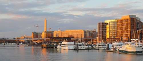 A waterfront view of Washington, D.C. underneath an overcast sky, as seen from the Wharf.