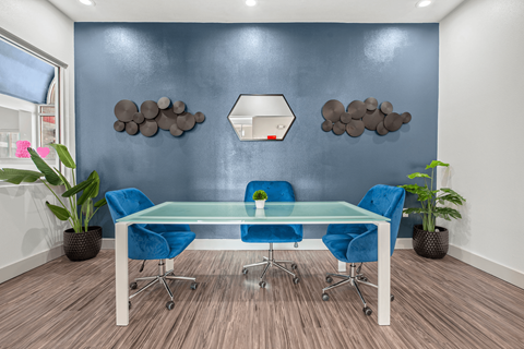 a conference room with blue chairs and a glass table  at Collective on Riverside, Austin